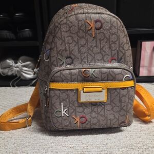 Calvin Klein Brown Monogram  Backpack with Yellow Accents